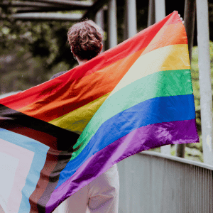 woman walking with Pride flag in Durham, NC