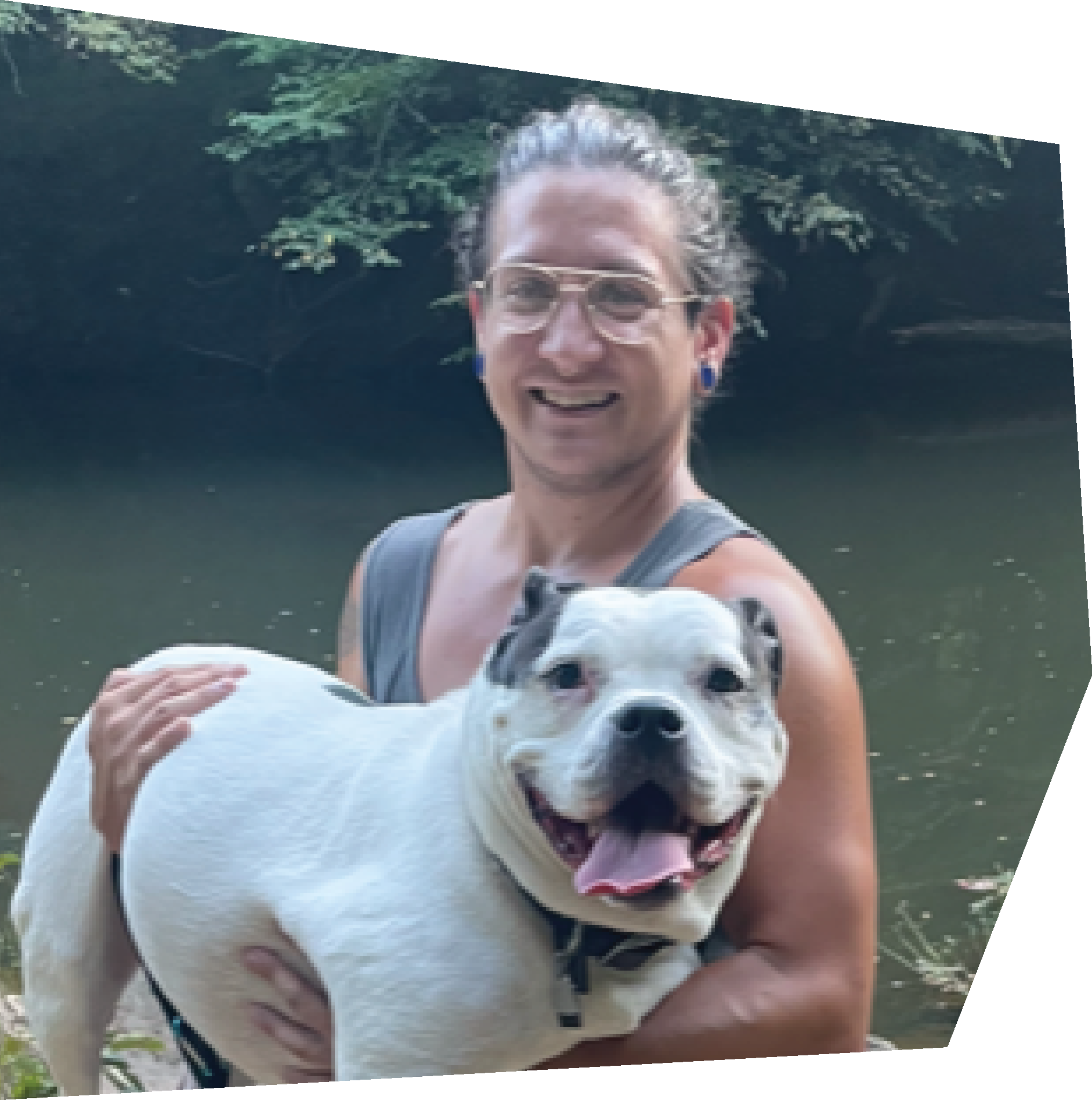 man holding large dog by a river