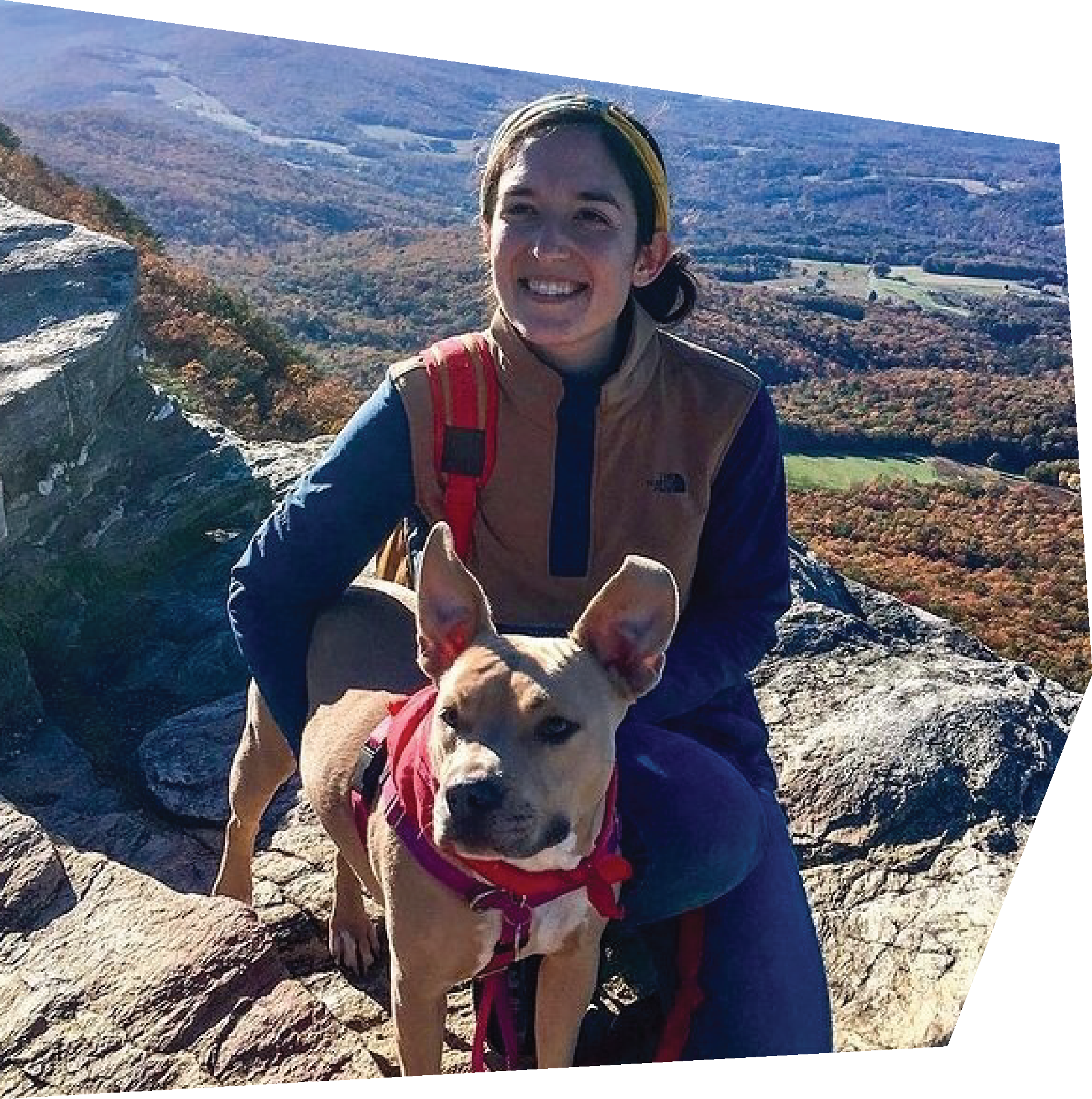 woman on mountain top with dog