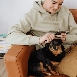 Why the kid next door is not a pet sitter - kid on phone with dog in Durham, NC